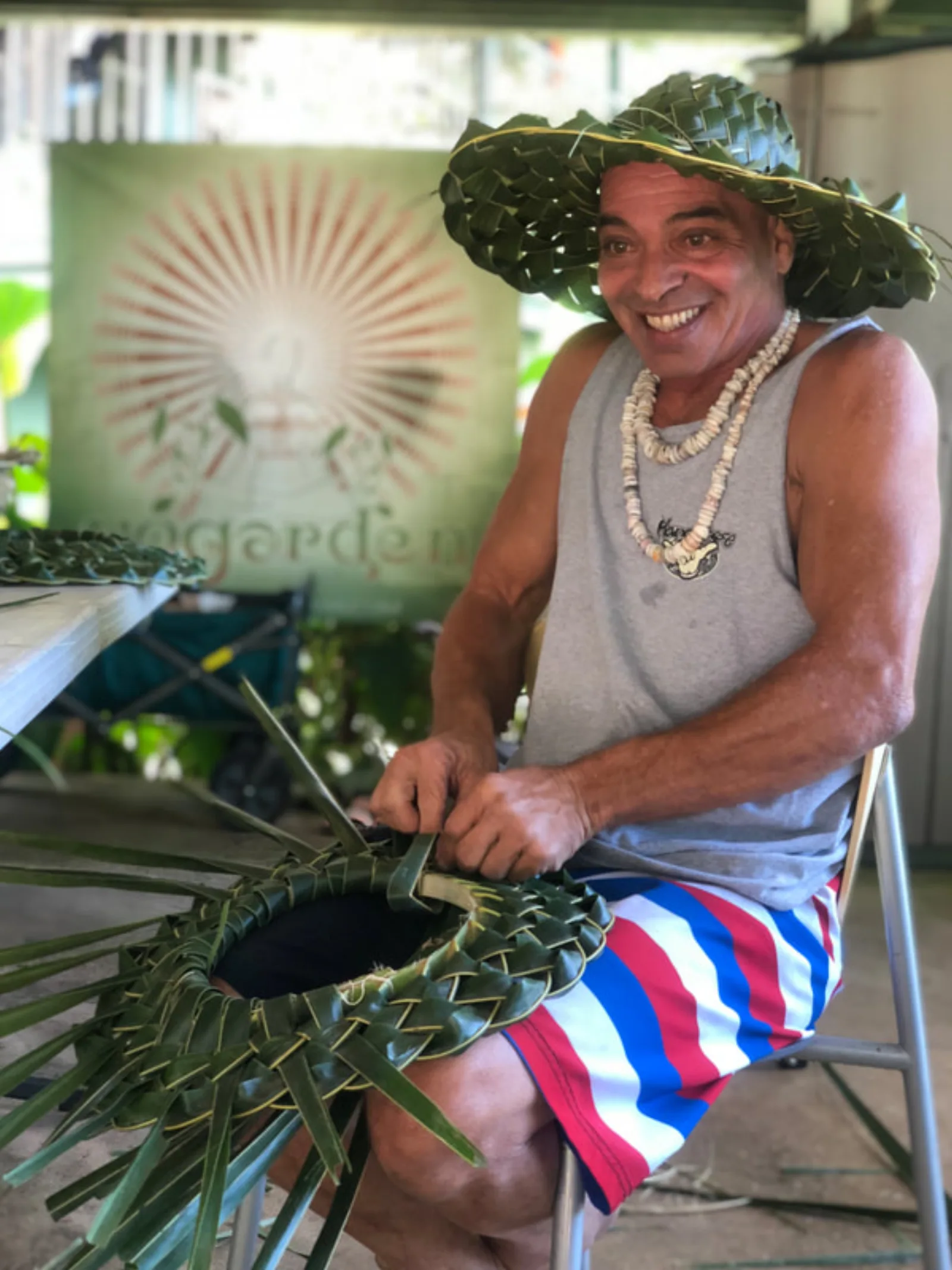 A teacher demonstrating traditional leaf weaving