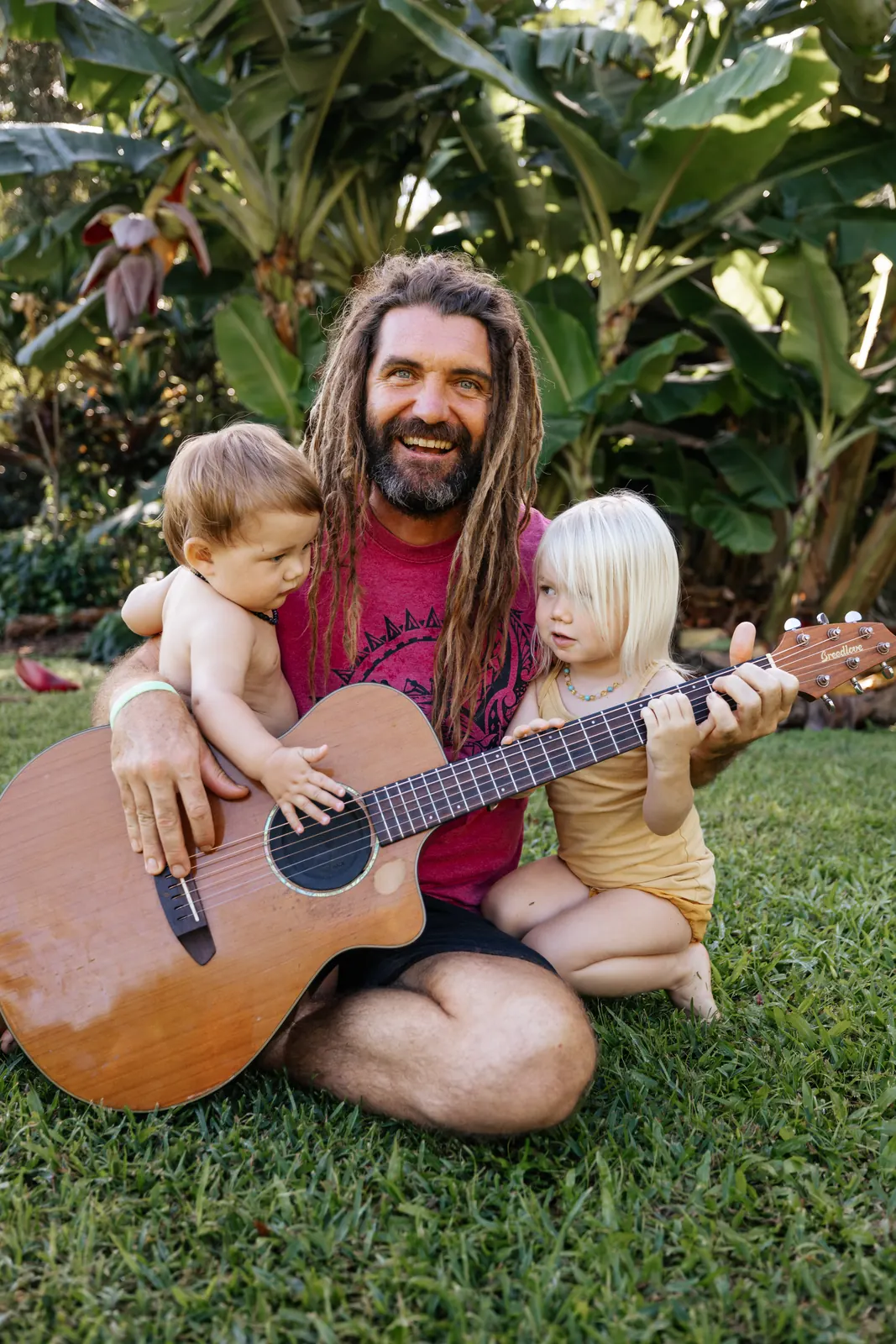 Paul Izak sharing music with two young children at Yogarden